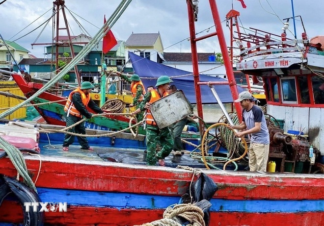 Cán bộ, chiến sỹ Đồn Biên phòng Diễn Thành (Bộ đội Biên phòng tỉnh Nghệ An) triển khai lực lượng hỗ trợ ngư dân đưa tàu thuyền vào nơi tránh trú bão, neo đậu, chằng néo phương tiện, thu dọn ngư lưới cụ. (Ảnh: TTXVN )   Cán bộ, chiến sỹ Đồn Biên phòng Diễn Thành (Bộ đội Biên phòng tỉnh Nghệ An) triển khai lực lượng hỗ trợ ngư dân đưa tàu thuyền vào nơi tránh trú bão, neo đậu, chằng néo phương tiện, thu dọn ngư lưới cụ. (Ảnh: TTXVN )